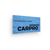 Banner promozionale CARPRO con logo e slogan "Extraordinary Works" su sfondo blu con gocce d'acqua