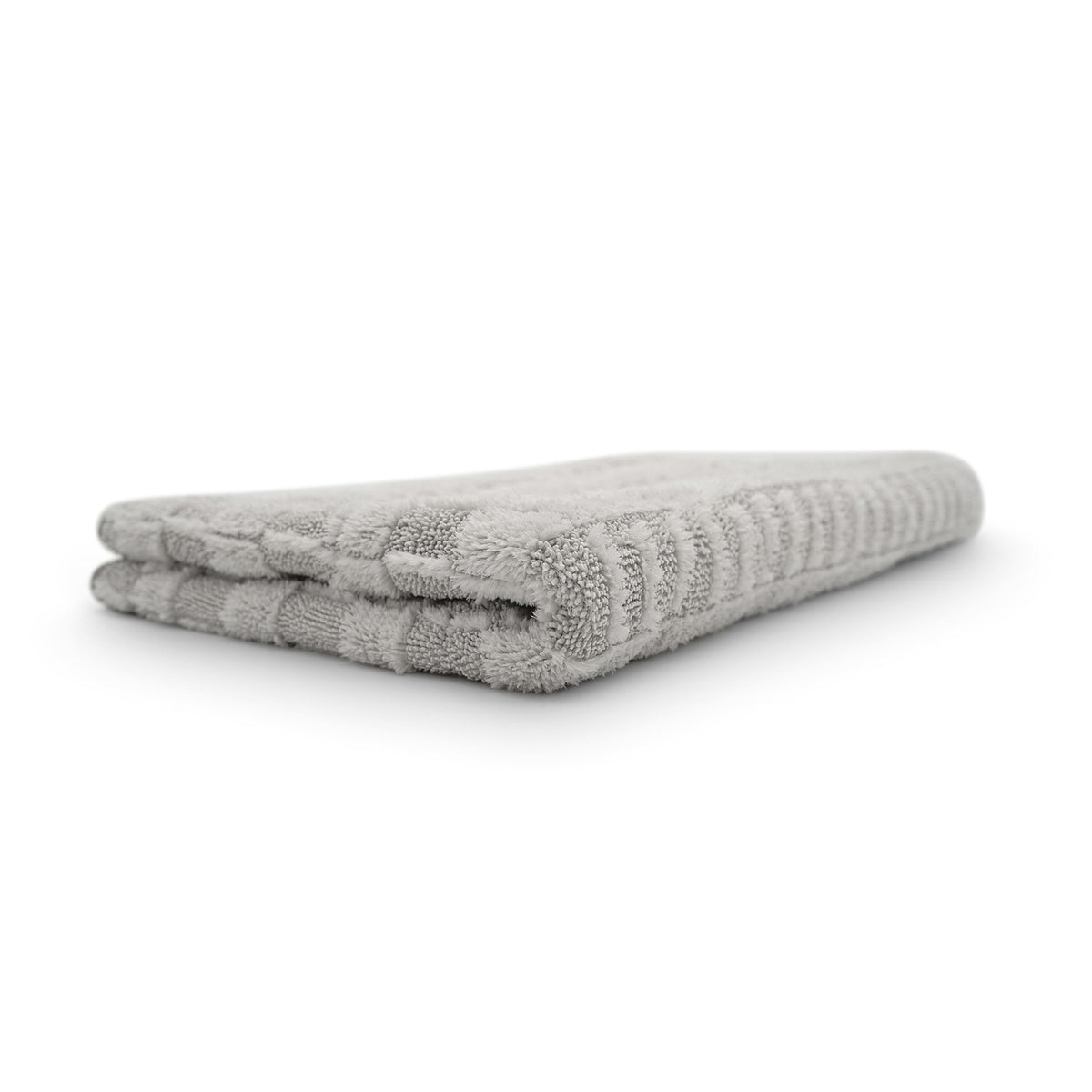 Panno asciugatura Stripped 2.0 in microfibra grigia, piegato, con un design a righe.